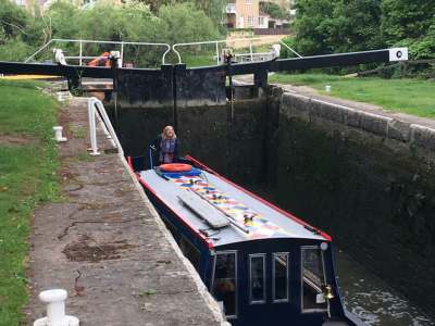 Sue Smith at the helm of nb Litania in a lock on the Kennet & Avon Canal.