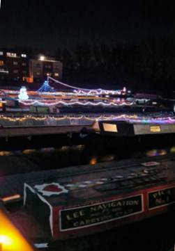 Decorated boats lit up in the Aylesbury Canal Society basin.